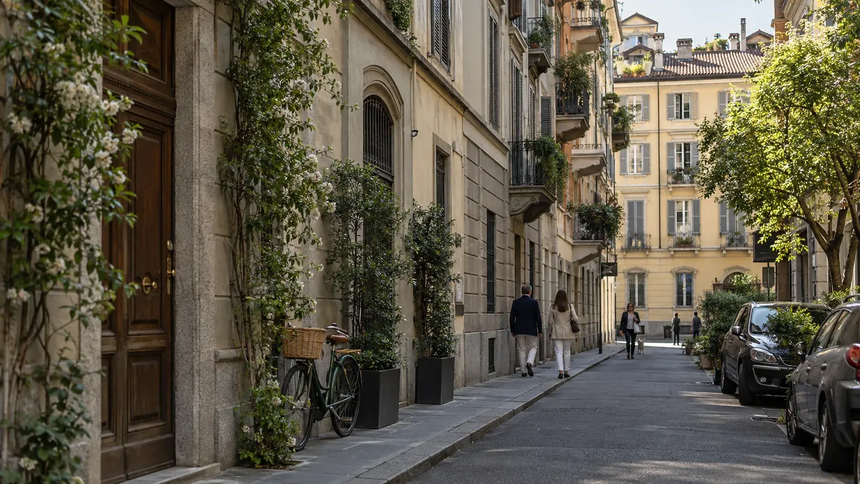 A quiet Milan side street in the morning, people walking past shuttered facades and a bicycle at a doorway